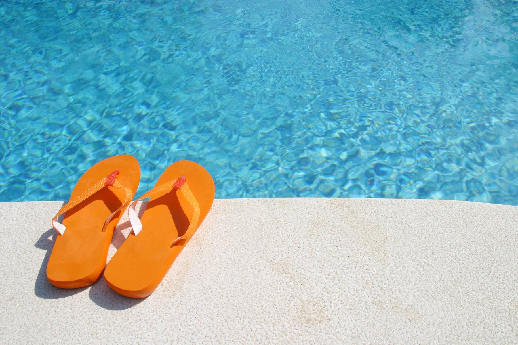 orange flip flops by pool